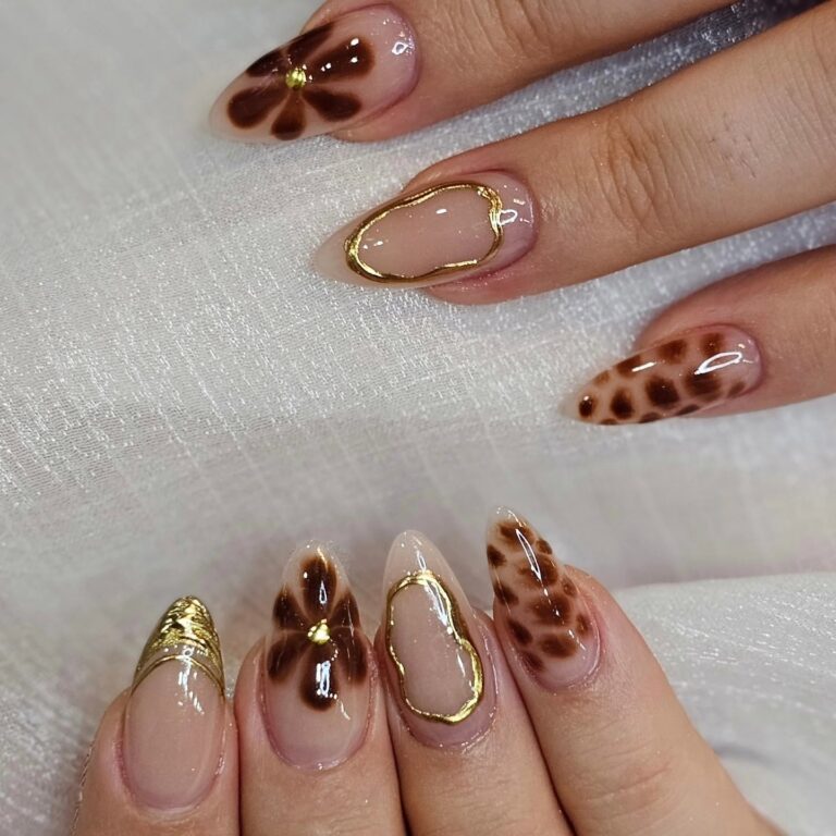 Leopard-print almond nails with gold accents at EM Nails & Beauty Bar Edmonton